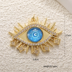 Detail view of gold evil eye pendant with crystal stars and measurements 3.8cm by 3.3cm
