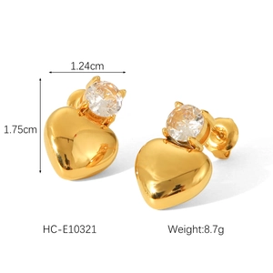 Macro detail of gold 18K textured stainless steel heart earrings with crystal studs