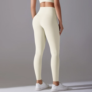 Detailed back view of high-waisted seamless yellow yoga leggings showing sculpting fit