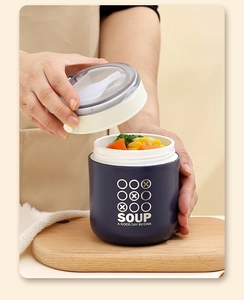 Detail of portable blue soup cup with lid open showing built-in folding spoon and food