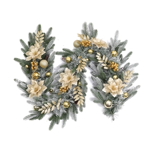 Close-up of snowy Christmas garland with golden flowers, berries and glitter ornaments