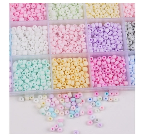 Detailed macro view of 4mm colorful glass seed beads set in a transparent storage box