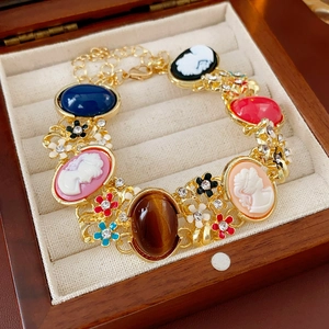 Detailed macro of vintage cameo bracelet with colorful gems and floral enamel charms