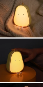 Detail of pear-shaped silicone night light showing soft texture and hand-touch operation