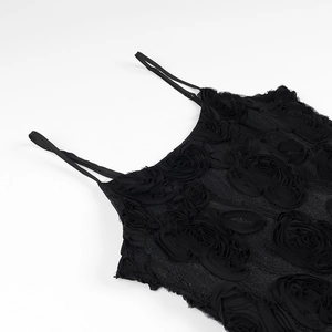 Detailed close-up of 3D black floral appliqués and lace texture on a sleeveless dress