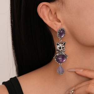 Retro silver drop earrings featuring a cat head charm and purple gemstone pendant