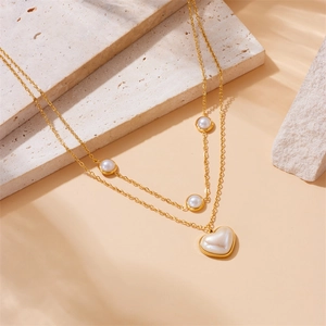 Double-layered gold stainless steel necklace with cream pearls and heart pendant