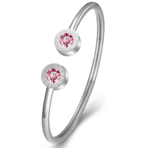 Detail of silver bangle with pink birthstones and engraved Roman numerals around the edge