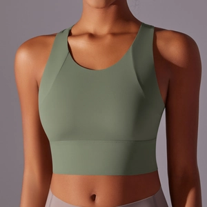 Detail of sage green yoga sports bra with wide straps and high-elastic matte fabric