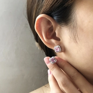 Close-up of pink Asscher cut square sugar stud earrings with halo zircon setting