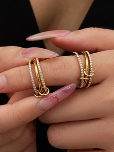 Macro shot of 18K gold three-link ring set with micro-pave zircons and connector rings