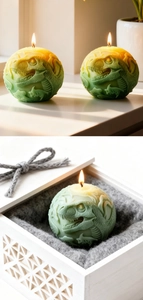 Detailed relief dinosaur skull carving on a gradient sphere candle in a gift box