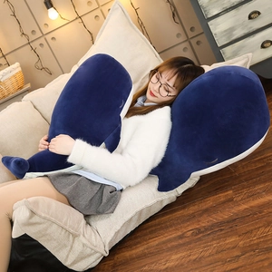 Detailed close-up of blue plush whale pillow shell with cute embroidered closed eyes detail