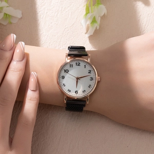 Detailed close-up of a women's watch with rose gold case and magnetic mesh strap