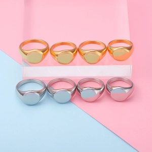 Minimalist gold and silver stainless steel signet rings on acrylic display stands