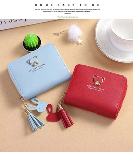 Detail of mini zip purses in light blue and red with cute bear buckle and tassels