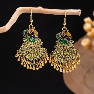 Detailed view of cloisonne peacock earrings with colorful enamel and golden teardrops