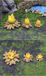 Detailed macro view of miniature resin bonfires with realistic wood textures for garden decor