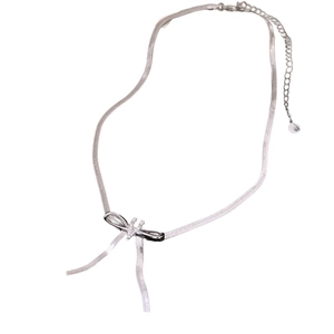 Silver snake chain necklace with a zircon-encrusted bow pendant on white background