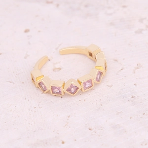 Detailed macro view of gold-plated adjustable ring featuring square pink zircon stones