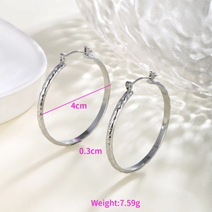 Detailed view of silver hoop earrings showing 4cm diameter and textured chain pattern