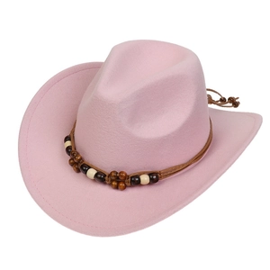 Detail of pink felt cowboy hat featuring a bohemian style beaded and braided hatband