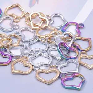 Detailed view of hollow heart charms in gold, silver and iridescent vacuum plating