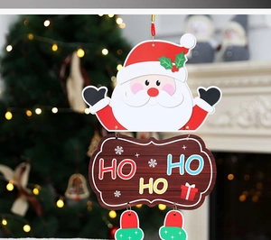 Close-up of Christmas paper hanging decor featuring Santa Claus and 'HO HO HO' greeting