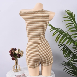 Detail of knitted striped two-piece set featuring back view of crop top and mini skirt