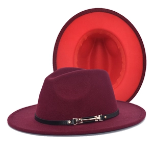 Detail of burgundy wool fedora with contrasting red brim underside and gold buckle