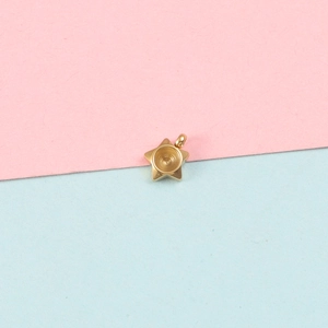Star shaped gold metal pendant base with round center setting on colored background