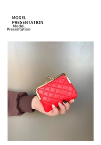 Detail of red quilted leather mini coin purse featuring gold metal kiss-lock closure