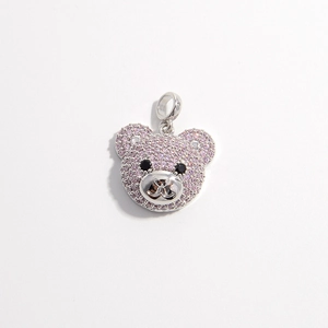 Detailed view of silver bear pendant featuring pavé pink cubic zirconia and black eyes