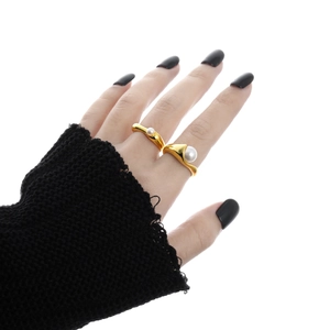 Elegant set of two S925 sterling silver gold rings with pearls on woman's hand