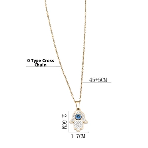 Macro view of a gold Hamsa pendant with an evil eye and crystal paving on a cable chain