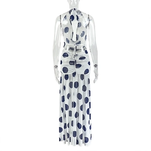 Detailed back view of a polka dot halter maxi dress with backless design and waist pleats
