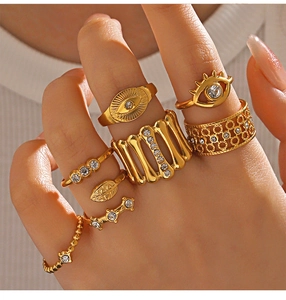 Macro shot of 8-piece gold bohemian ring set with evil eye and rhinestone details