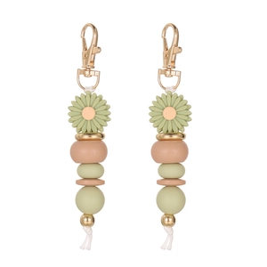 Detail of beaded daisy keychain with green flower bead and gold metal clasp on white