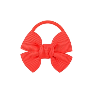 Detailed close-up of a red grosgrain ribbon bow attached to an elastic hair tie band