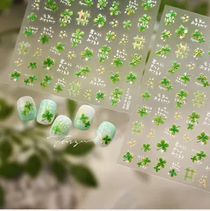 Detail of four-leaf clover nail stickers with laser glitter and green floral motifs