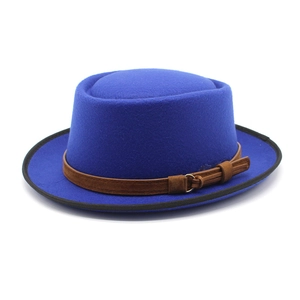 Detail of royal blue wool fedora with brown leather strap and metal buckle accent