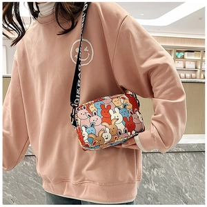 Detail of cute cartoon rabbit print on crossbody bag with lettered wide shoulder strap
