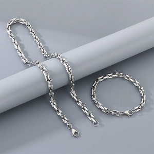 Detail of silver stainless steel chain necklace and bracelet set with lobster clasp