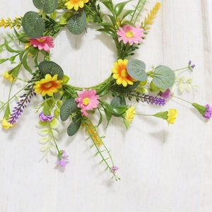 Floral wreath with pink daisies and lavender on a rustic white wood background