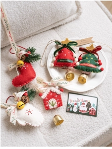 Detailed felt Christmas ornaments featuring festive stockings, trees, and golden bells