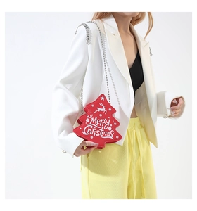 Detail of red Christmas tree shaped crossbody bag with silver bead chain strap and festive print