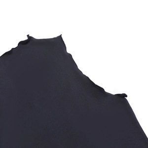 Macro view of black knitted fabric showcasing detailed ruffle edge and mesh texture