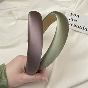 Set of two padded satin headbands in purple and green for elevated crown style