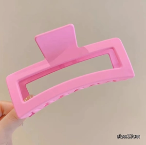 Detailed close-up of a 13cm matte pink rectangular claw clip for thick hair styling