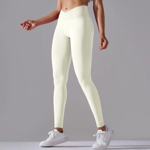 Detail of high-waisted seamless yoga pants with V-cross waistband in cream white knit fabric